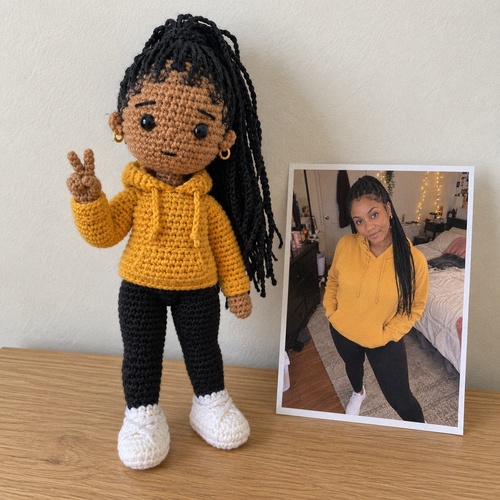 Crochet portrait of Maya, a sister in her twenties, next to the printed photo it was made from